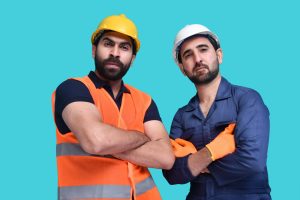 a couple of men wearing hard hats